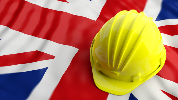 Yellow construction hat over UK flag hero image is PPE is for Life not just covid: The necessary role of personal protective equipment.